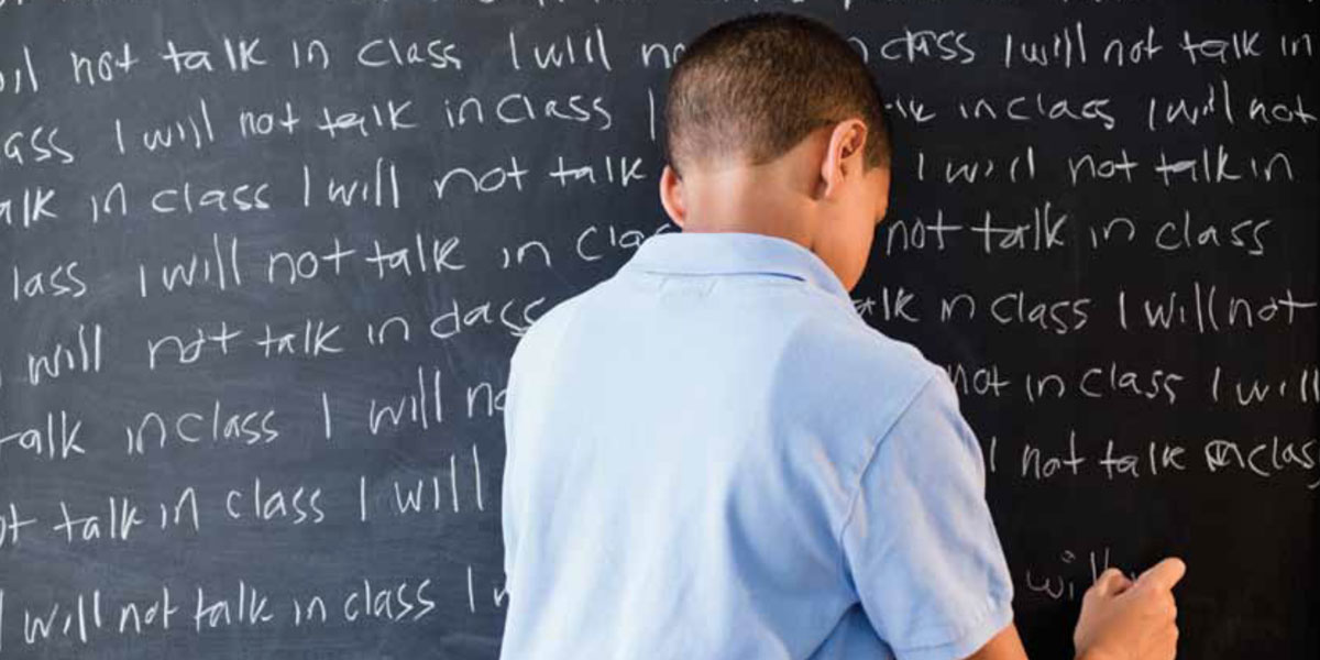 boy writing on a chalkboard