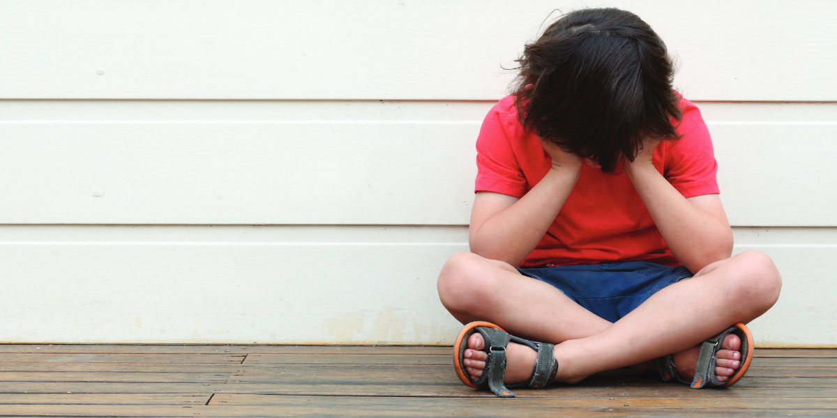 child with head in their hands