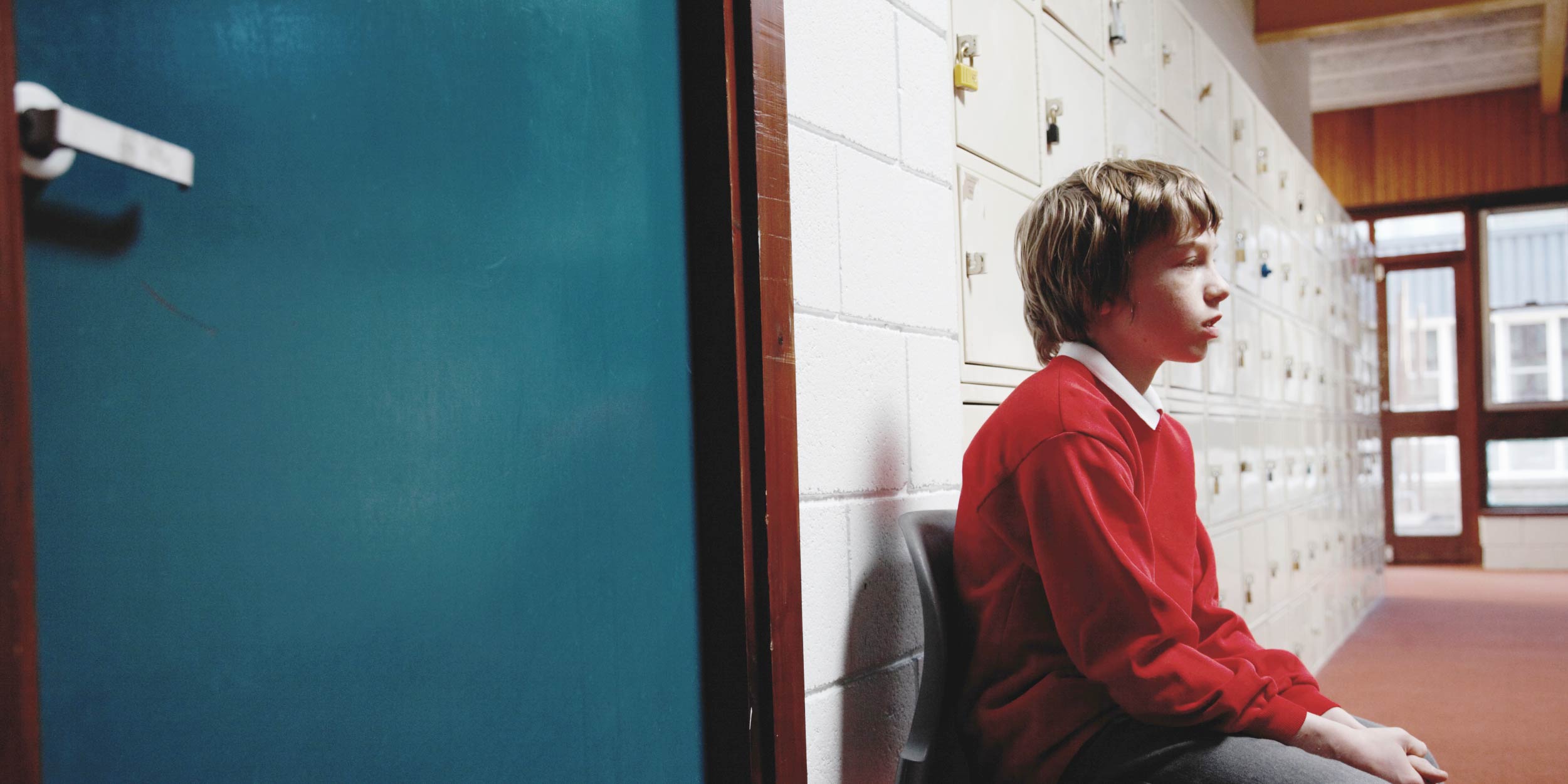 Student sitting outside of an office
