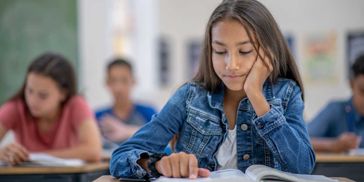 student reading in the classroom
