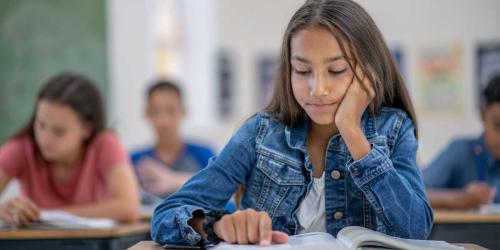 student reading in the classroom