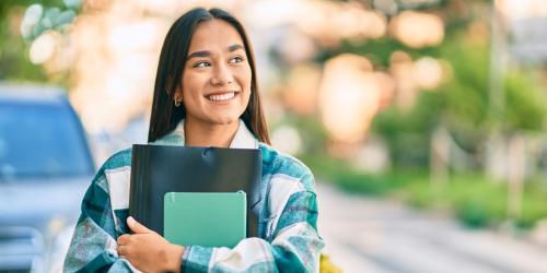 high school student holding a notebook