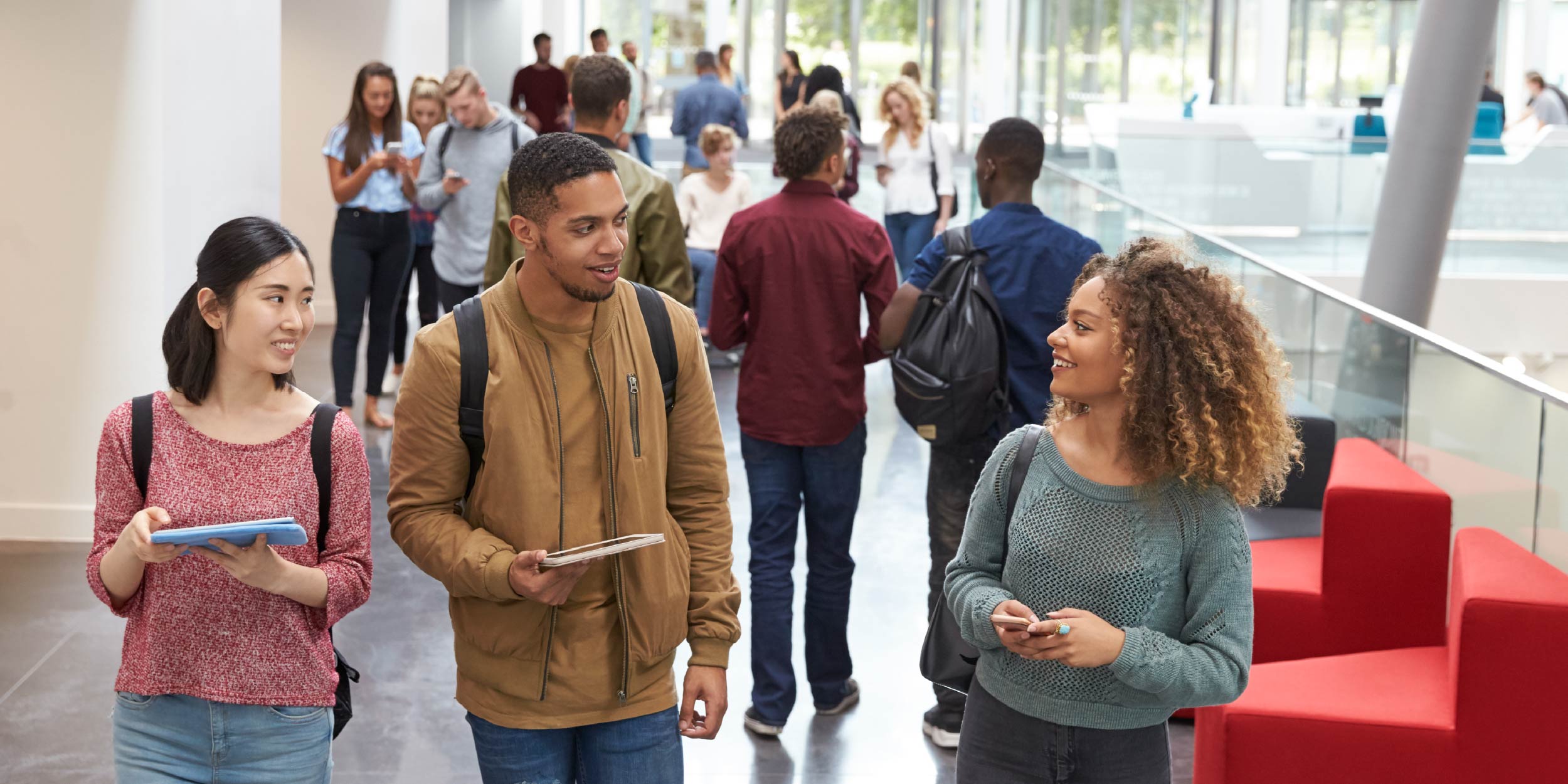 A group of community college students walking through the hall