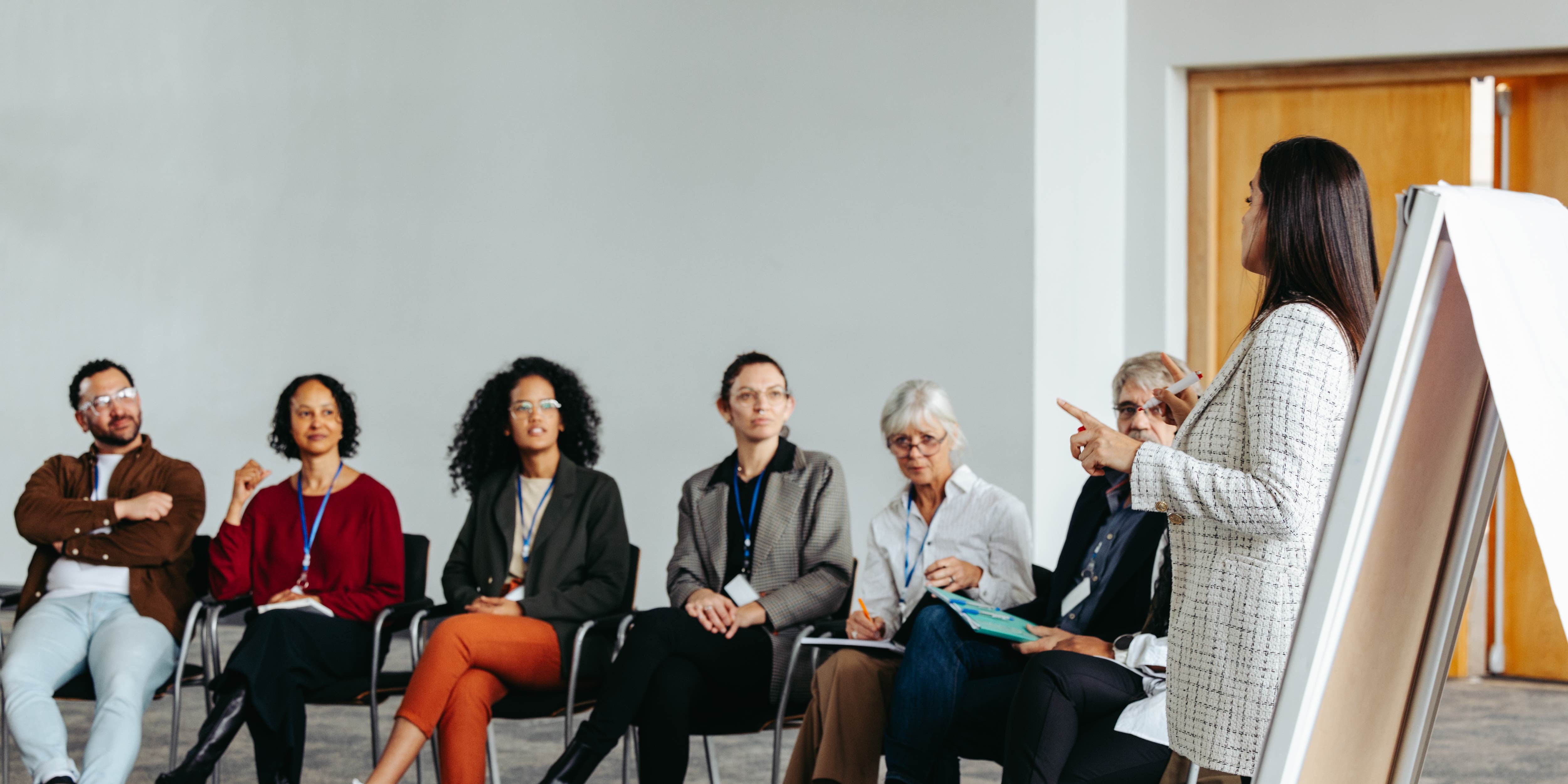 A person talking to a group of people