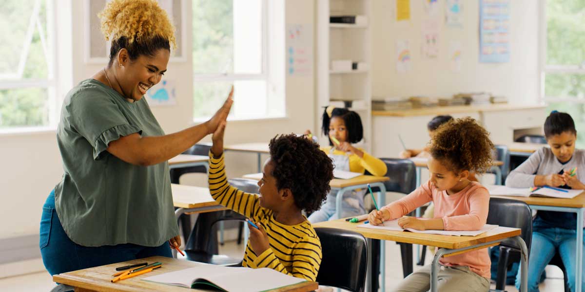teacher high fiving a student